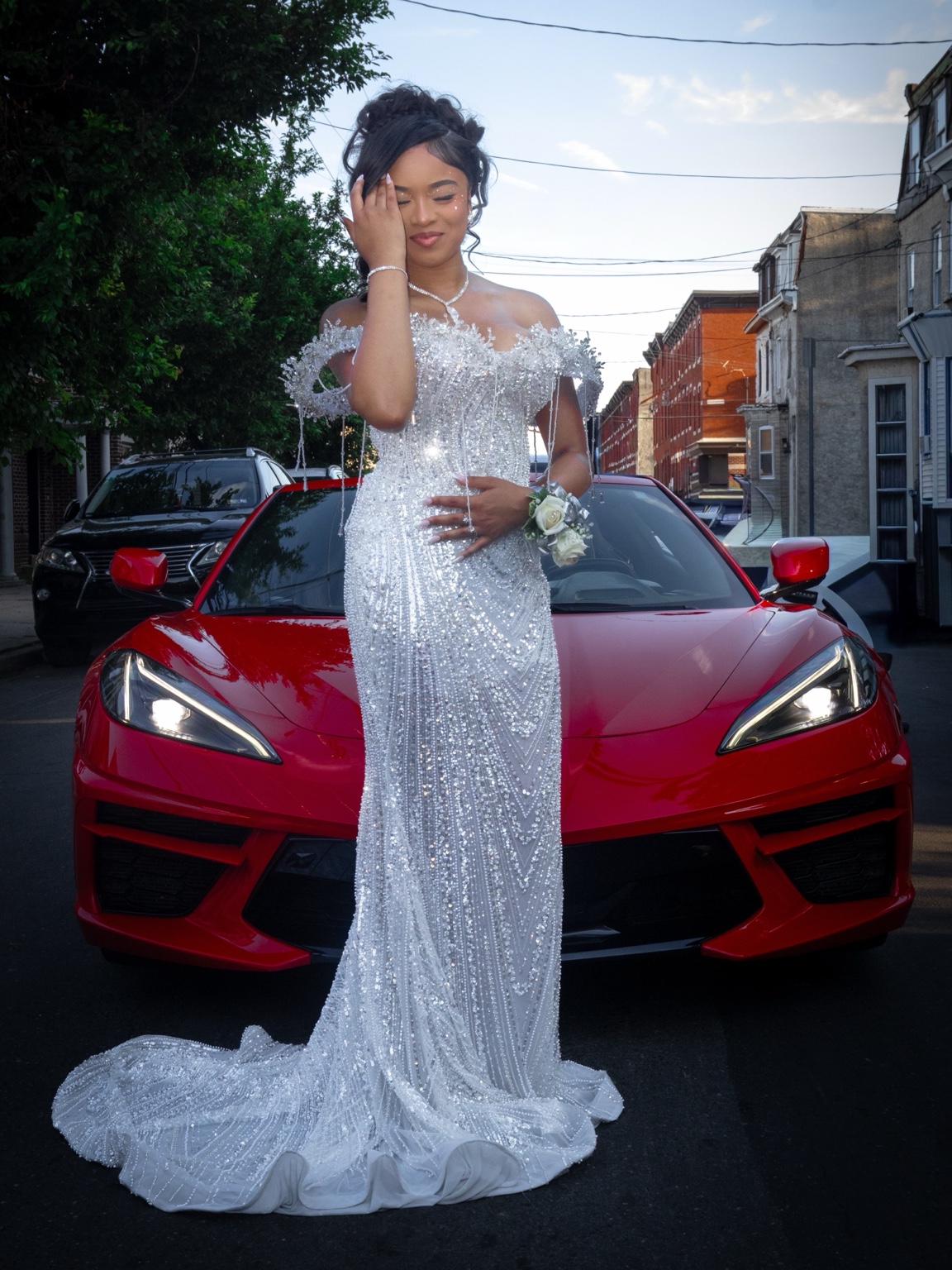 Prom portrait with a red sports car
