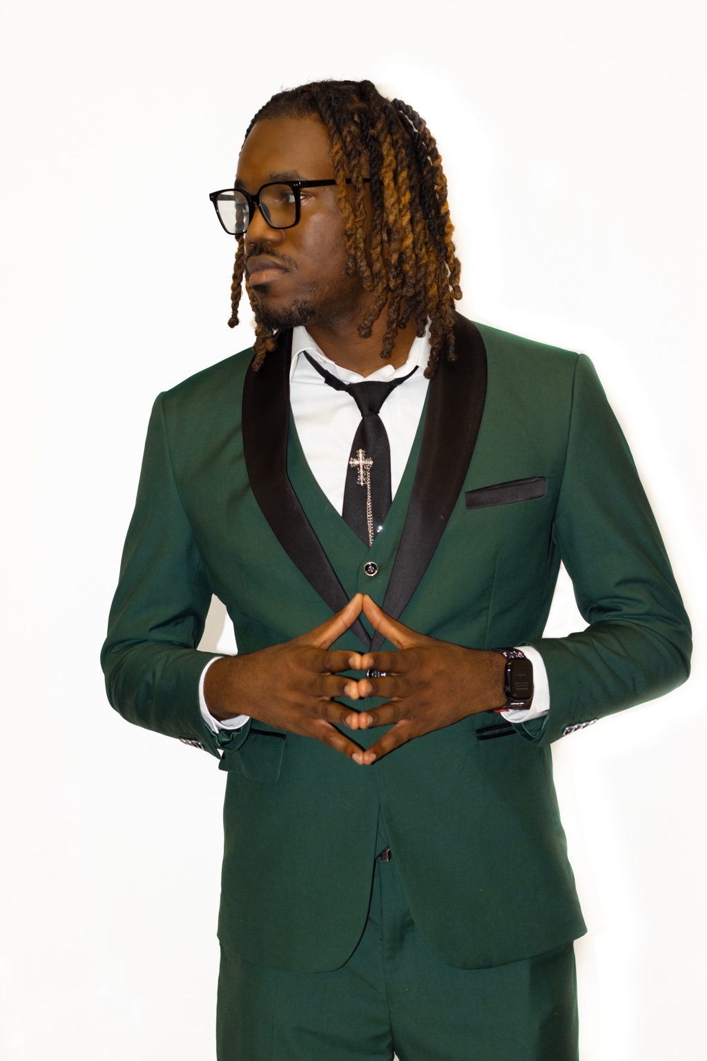 Formal studio portrait in a green suit